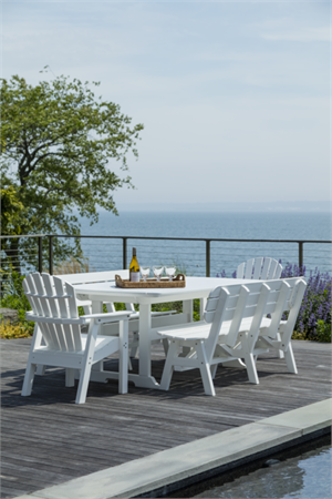 Seaside Casual White Poly Dining table by the pool over looking the water.