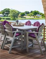 A set of balcony height adirondack chairs by Seaside Casual Furniture are shown on a deck overlooking a golf  course. GottaHaveItInc.com