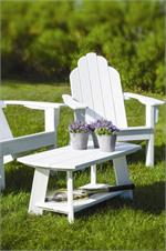 An adirondack coffee table shown on the lawn with an adirondack chair by Seaside Casual - GottaHaveItInc.com