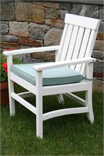 A Seaside Casual Hampton chair is shown with a stone wall in the background.